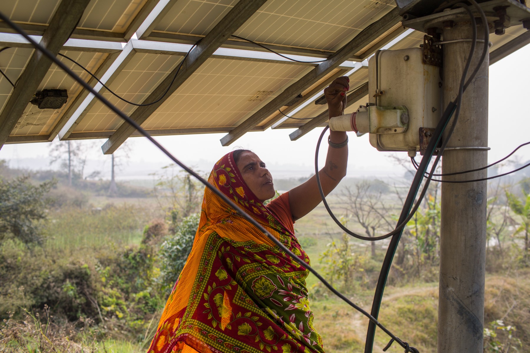 Woman farmer operating a solar pump system