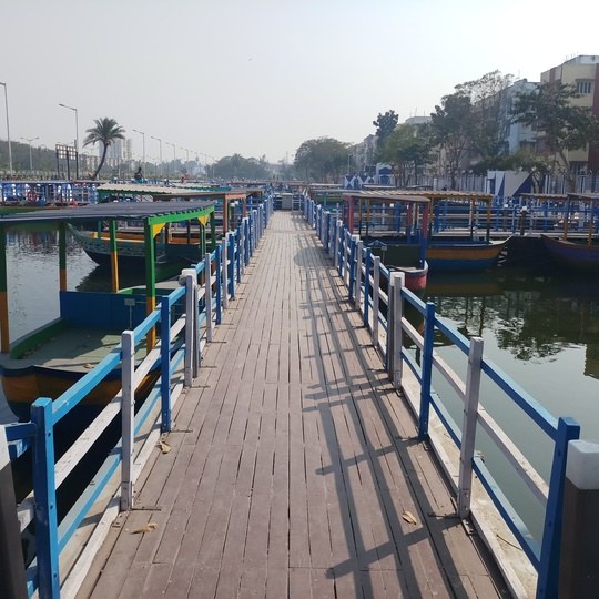 The wooden walkway between the boats selling wares. No dustbins can be found here to safely discard waste.