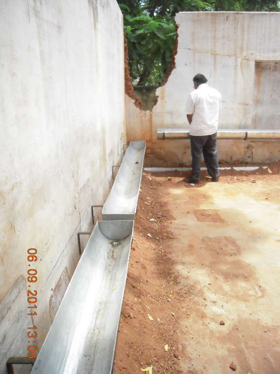 Pipes mounted on the school compound wall as a temporary urinal facility