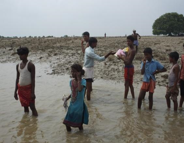 Children of Qutubpur village, Bhojpur, wait for help.