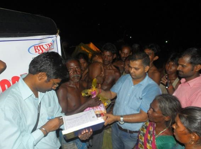 General Secretary (BJUP) distributes relief items at the Chittarbigha village in Patna.