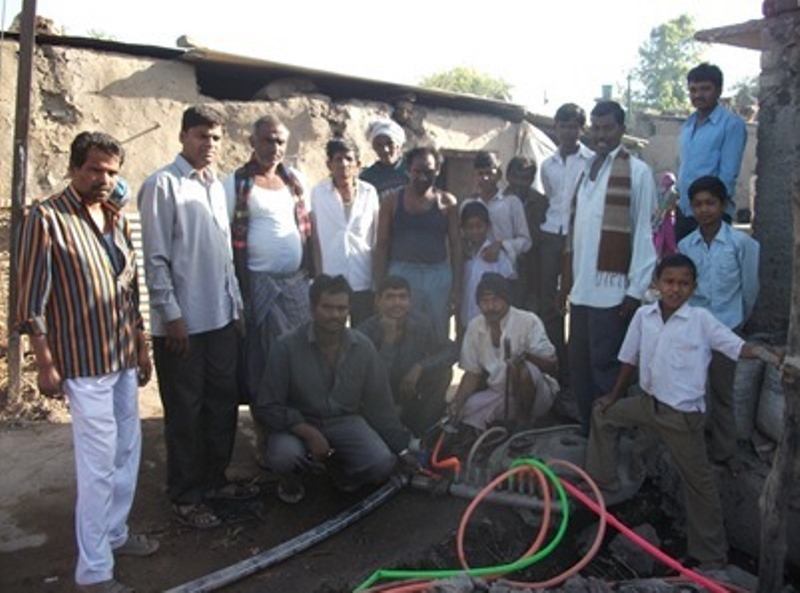 Manyali residents with the installed water supply pipe system
