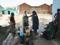 Women fill water from one of the taps at Pipara.