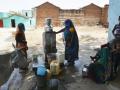 Women filling water from a tap (Source: IWP Flickr photos)