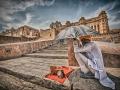 A man sits under the scorching heat of the sun in front of Amer fort in Jaipur. The city landscape is now dominated by heat trapping materials that prevent its cooling through evapotranspiration. (Picture courtesy: Prabhu B Doss, Flickr Commons: CC-By-NC-ND-2.0)