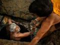 A latrine emptier is lifted out of a pit in Bangalore, India (Image: WaterAid/CS Sharada Prasad)