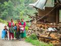 A family beside a damaged house near Naglebhare, Nepal (Source :Asian Development Bank)