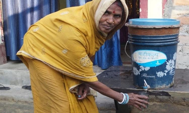 Meenadevi driking water from the low cost filter (Image Source: Sehgal Foundation)