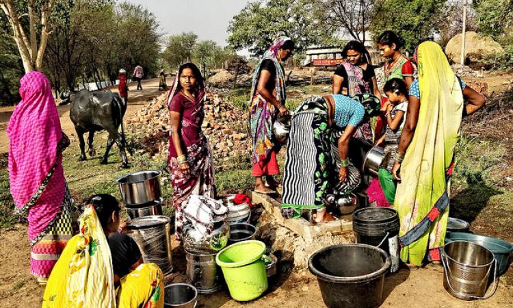 Women of Bagledi struggle to get a pot of drinking water from one of the four stand posts.(Pics: India Water Portal)