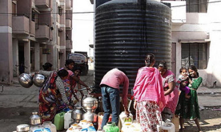 Residents struggle for a pot of drinking water at Bhuri Tekri, Indore.