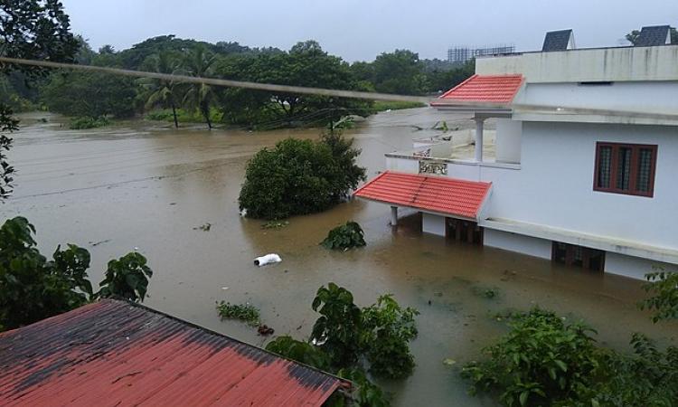 A house submerged in water during floods in Kerala. (Source: Ranjithsiji via Wikimedia commons)