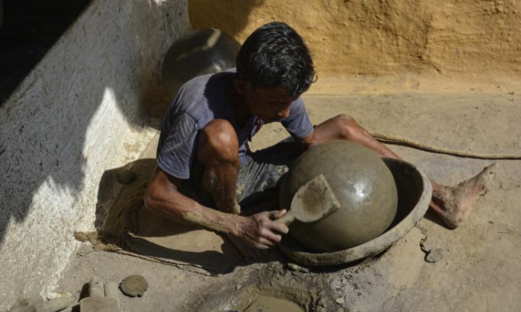 A potter making a clay pot in Jevra Sirsa village in Durg district