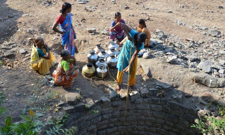 Women drawing water from a village well. Prior to watershed development and integrated water management, scarcity of water was a way of life for the people of Kumbharwadi (Image: WOTR)