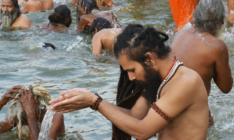 A priest offers water to the sun at Ramghat on the Kshipra river at Simhastha (Image Source: Makarand Purohit)