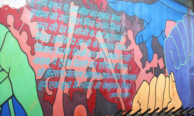 A poem that describes how the city was left destroyed is written on a wall near a memorial for those killed & disabled by the Bhopal gas tragedy, 1984