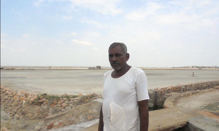 Ramachander Singh, a salt worker who has been raking salt for decades now at this salt pan or kyari dotting the lake bed of Sambhar, Rajasthan.