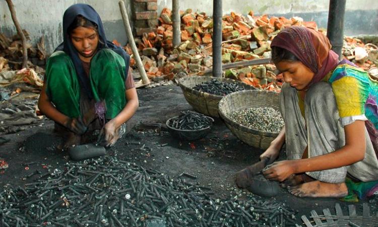 Two girls recycle metal from used batteries at a workshop in Dhaka, Bangladesh (Image: UNICEF/Naser Siddique)
