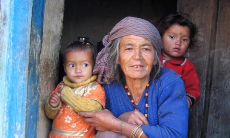 A woman with her grandchildren in her Munsyari home.